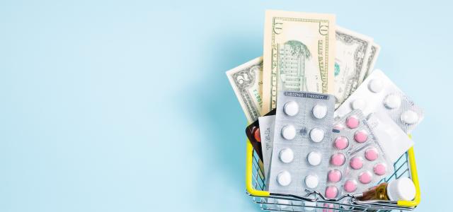 a shopping cart filled with pills and money by Anastasiia Gudantova courtesy of Unsplash.